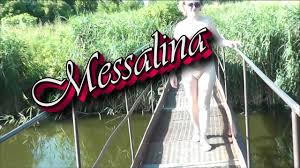 Messalina Dressed in Sun. Outside Outdoor. Nude Milf walks by bridge River.  Naturist Nudist Woman