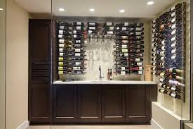 Application of spray foam is essential for this glass wine cellar built in a modern home. Metal Custom Wine Racks For Building Elegant Wine Cellars