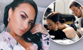Barker added an homage to his girlfriend, kourtney kardashian to his heaping collection of tattoos spanning across his body. Demi Lovato Debuts New Butterfly Neck Tattoo And Possible New Song Lyrics Daily Mail Online