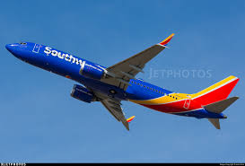 Two people look out at a southwest airlines boeing 737 max 8 airline that came in from las vegas as it sits at gate b20 at midway airport in chicago on march 13, 2019. N8711q Boeing 737 8 Max Southwest Airlines John Klos Jetphotos