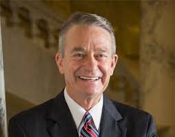 In federations, governor may be the title of a politician who governs a constituent state and may be either appointed or elected. Idaho Governor Brad Little