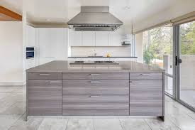 The oversized kitchen hood covers the sink area as well, making a large impact against the contemporary cabinets. Modern Kitchen With Large Island Novocom Top