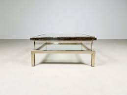 The black glass top is surrounded by a bronze frame sitting on crossed bronze legs. Sliding Coffee Table From Maison Jansen 1970s For Sale At Pamono