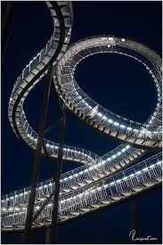 'tiger and turtle,' which looks like a roller coaster, is illuminated in duisburg, germany. Tiger Turtle Duisburg Magic Mountain Im Ruhrpott