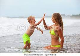 Check spelling or type a new query. Happy Family On Family Beach Vacation Happy Family Lifestyle At Beach Sea Surf Young Mother In Bikini Giving High Five To Canstock