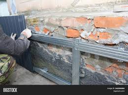 We have a brick veneer on the front face of the foundation wall that goes down about 4 bricks in depth on that foundation by way of a brick ledge, making that foundation top side smaller than the rest of the other foundation walls. Brick House Foundation Image Photo Free Trial Bigstock