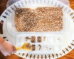 You can also share with your child how the different kitchen tools are used. Scoop Pour And Transfer With Beans An Easy Sensory Bin Idea Happy Toddler Club