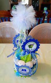 My Sons Monsters Inc Baby Shower Diaper Cake Centerpieces Compliments Of The Talented And Baby Shower Centerpieces Baby Shower Fun Monsters Inc Baby Shower