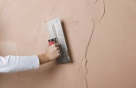 Plastering an external wall using sand and cement. Plaster Designing Buildings Wiki