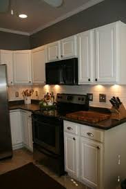 kitchen cabinets with black appliances