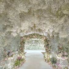 Wedluxe Media On Instagram A Tunnel Coated In Baby S Breath And Subtle Pops Of Pastel Blooms Creat Babys Breath Wedding Wisteria Wedding Flower Wall Wedding