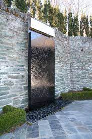 Water trickles from the top of the mirror onto the bed of rocks to mimic the sounds of a waterfall, adding ambiance to your living room, office, or hallway Contemporary Water Sculptures Mirror Black Stainless Steel Water Sculptures Water Feature Wall Outdoor Wall Fountains Water Features In The Garden