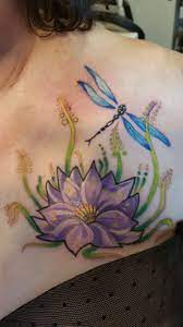 Beautiful dragonfly and flower tattoo. My Beautiful Purple Lotus Flower And Dragonfly Tattoo It S Rich With Meaning And Symbolism And I Dragonfly Tattoo Dragonfly Tattoo Design Purple Lotus Tattoo