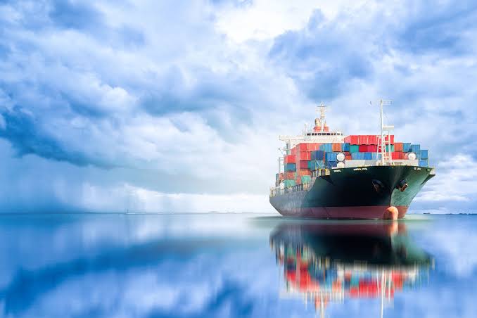Modern commercial tanker and bulk carrier at port