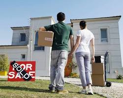 Image of young couple looking at a house with a sold sign