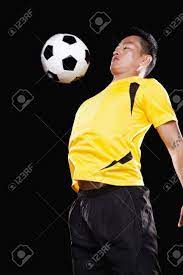 Footballer Chesting Ball, Black Background Free Image and Photograph  35985780.
