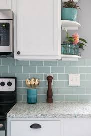 Frosted Sea Glass Subway Tile White Cabinets And Recycled Glass Countertops Make For A Coastal Coastal Kitchen Design Coastal Cottage Kitchen Coastal Kitchen