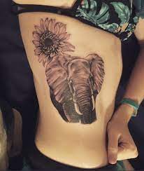 Elephant And Rising Sun Flower Tattoo Elephant Tattoos Sunflower Tattoos Sunflower Tattoo Thigh