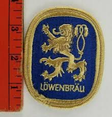 A trident as a symbol for the navy was added, and a shield with a spade as a symbol for death with red and yellow colours as found on the flag of south vietnam. Lowenbrau Munich Beer Embroidered Patch Ale Advertising Logo Vintage Merchandise Memorabilia Collectibles