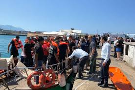 A photo showing rescue boats near the capsized ferry off the coast of Kyrenia, with people in life vests in the water.