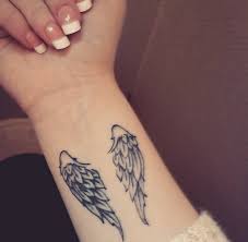They are usually naked, have wings, look like a baby angel (usually male) and are sometimes pictured sitting on. Small Wing Tattoo On Forearm Tattoo Design