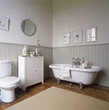 For us, the luan panels had to sit on top of the baseboard in order to reach far enough up the wall to cover all the damaged areas. How To Wood Panel A Bathroom Wall Wood Panel Bathroom Beadboard Bathroom Bathroom Wall Panels