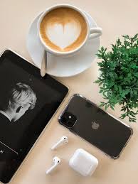 Black Iphone 11 Beside Airpods And Coffee Cup Free Stock Photo