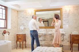 The whole family was sitting in the room. Couple Getting Ready At Hotel Bathroom Mirror People Routine Stock Photo 255074666