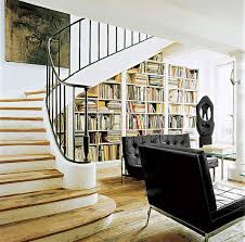A vintage graphite grey bookcase, lamps and comfy chairs for creating a cozy reading nook under the stairs reading nook with shelves and a comfy lounge chair and enough light Cabinet Under The Stairs In A Private House Stylish And Practical Solutions Make Simple Design