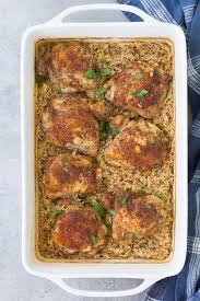 In This Easy Baked Chicken And Rice Casserole Tender Chicken Thighs And Rice Cook Toget Easy Rice Recipes Boneless Chicken Thigh Recipes Easy Chicken And Rice