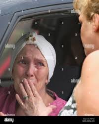 Alice Esteban, right, talks to an unidentified woman in front of the  Hernandez residence in Omaha, Neb., Monday, Aug. 23, 2004. Maria  Hernandez-Montanez, 35, and three of her five daughters, Candy Hernandez -Montanez,
