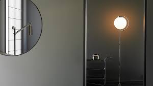 The large, round lamp head, or shade, is a gold iron spotlight with a slightly diffused glass cover. Bauhaus Floor Lamps Tecnolumen