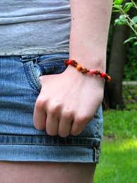 Starting with one end, lay the knotting cord over the other side of the cord. Friendship Bracelets And How To Tie A Sliding Knot
