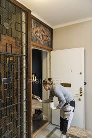 Aluminum screen doors, also known as storm doors, typically serve a functional rather than aesthetic purpose. Painter Painting Door Frame In Apartment Building Woman Paint Can Stock Photo 307032826