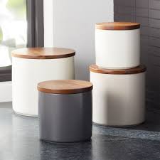 Shop Silo Wood Lid Canisters We Ve Warmed Our Clean Contemporary Canisters With A Creamy Glaze And Staine Lidded Canisters Ceramic Canisters Crate And Barrel