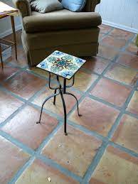 The table is a beautiful decorative piece that is also fully functional. Tile With Iron Base Table Plant Stand Antiques Board