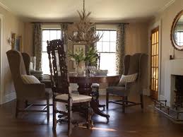 These serve as a dynamic background for the simple white wooden dining table and its contrasting dark wooden chairs on a gray floral area rug. English Country Dining Table Houzz