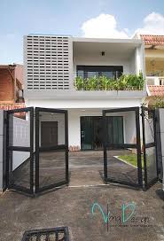 Simple Yet Fascinating Terrace House Exterior Design Featuring Vented Wall And A Balcony Lined With Plant Terrace House Exterior House Gate Design Facade House