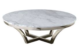 The tabletop is made from thick, clear glass, tempered for safety and durability, and is supported by a singular base design. Nuevo Aurora Coffee Table