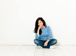 Can't play beautiful in blue? Beautiful Young Woman With Black Hair And Blue White Striped Sweater Sitting On The Ground In Front Of White Background Hmef00417 Epiximages Westend61