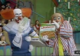 Here is a screenshot of Bozo and Cooky The Clown at the Grand Prize Game at  Bozo's Circus. Cooky is holding a box of John's Pizza. Courtesy of  FuzzyMemories.TV