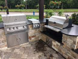 Outdoor kitchen with charcoal grill and smoker. Outdoor Kitchens Pitts Spitts Smokers Grills