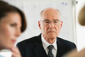 Serious senior businessman looking away stock photo