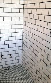 Black And White Penny Tile Floor Bathroom 10 Tips To Revamp Your Bathroom At A Low Price In 2020 With Images Tile Walk In Shower White Brick Tiles Subway Tiles Bathroom