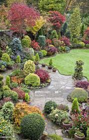 Https Media Gettyimages Com Photos Japanese Maples And Evergreen Shrubs Surround Nea Japanese Maple Tree Landscape Maple Tree Landscape Japanese Maple Garden