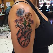 The long stem of this flower is inked across the chest and almost seems to move with the body. 69 Heart Tattoos Designs And Ideas