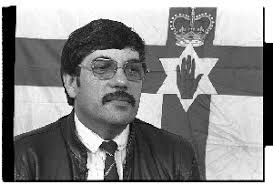 Andy Tyrie, Supreme Commander, UDA, in front of Ulster Flag