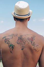 A Young Man With A Tattoo On The Back Of The World Map By Lydia Cazorla For Stocksy United Buyuk Dovme Karizmatik Dovmeler Erkek Dovmeleri