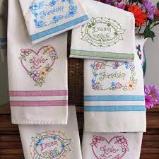 Thread the machine embroidered kitchen towels the first color suggested or the color of your choice. Pretty Flowers Hand Embroided On Bright Tea Towels