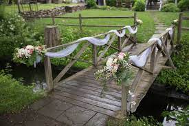 Lovely White Tulle With Beautiful Bouquets Of Fresh Flowers Gracefully Drapes The Bridge At The Inn Pond Wedding Barn Wedding Decorations Pond Wedding Ceremony